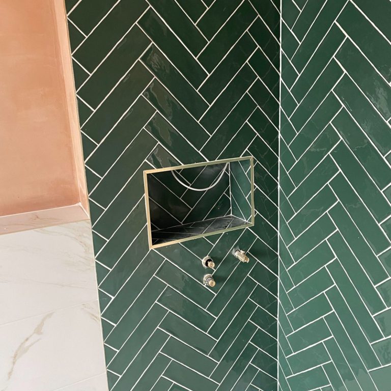 herringbone tiling by FIS Finishes, fisfinishes.com local tiler. Green tiles in herringbone with white grout to shower area.