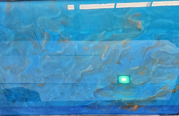 A tranquil underwater scene with jellyfish swimming in blue water.