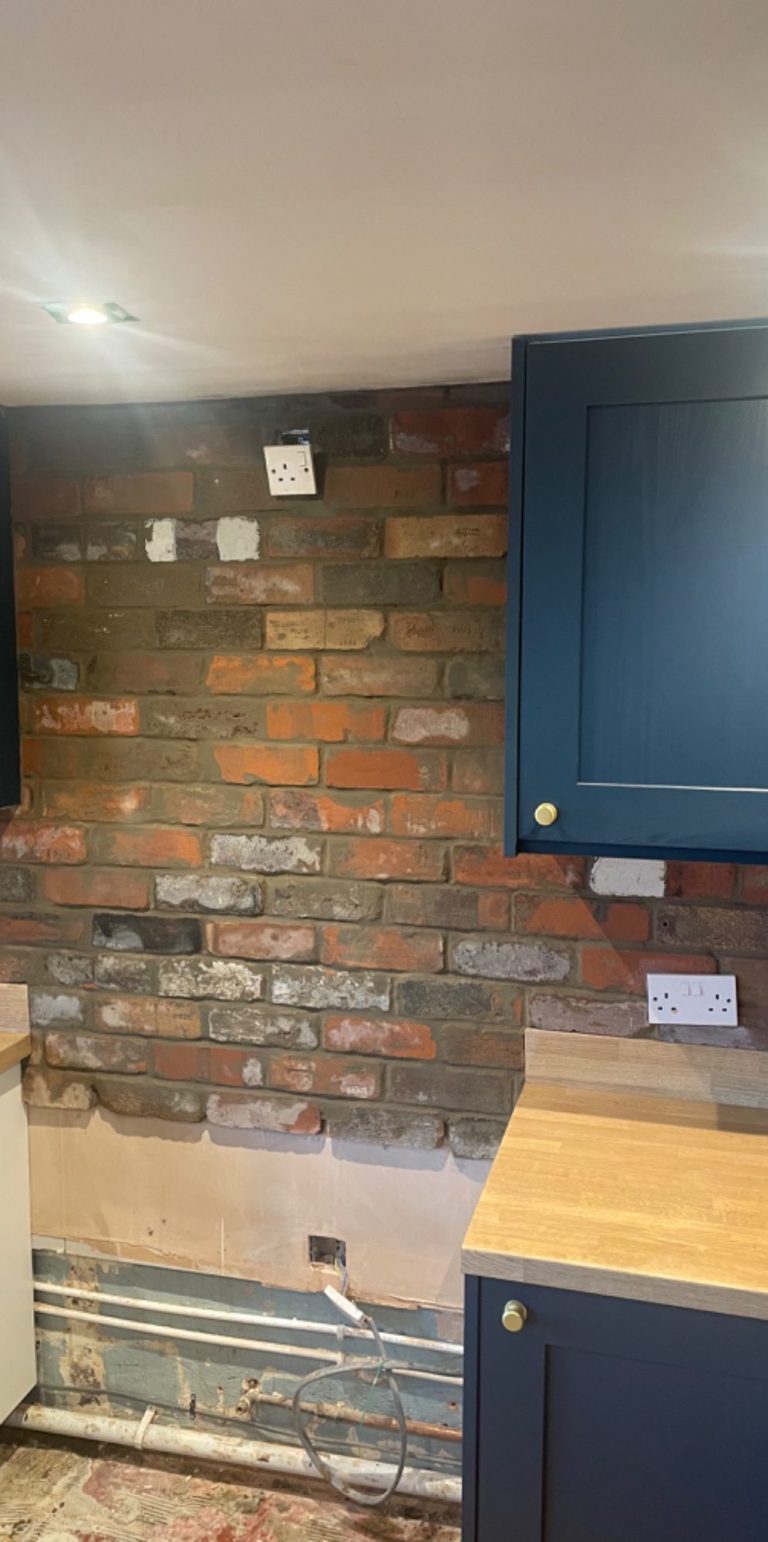 Brick slip tiling with cement morter in kitchen.